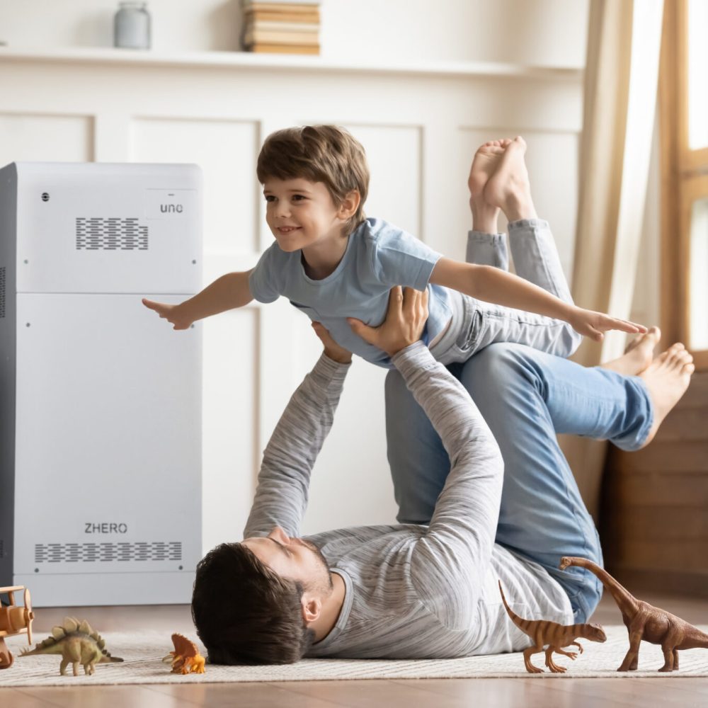 Joyful,Young,Man,Father,Lying,On,Carpet,Floor,,Lifting,Excited Joyful young man father lying on carpet floor, lifting excited happy little child son at home. Full length carefree two generations family having fun, practicing acroyoga in pair in living room.